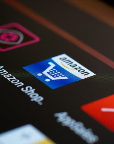 Close-up of the Amazon shopping app icon on a smartphone screen. Ideal for online shopping and technology themes.